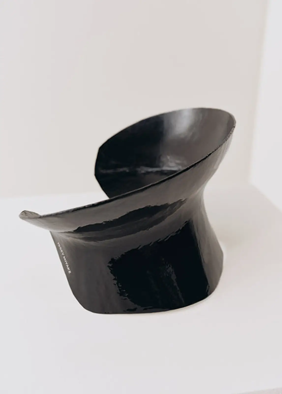 The black corset as an object. ISSEY MIYAKE printed on the side.