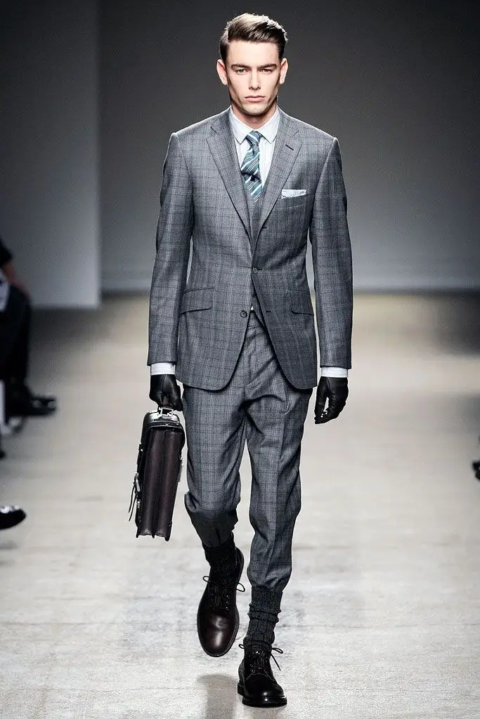 Dunhill, Fall 2010. A grey three-piece, briefcase in hand.
