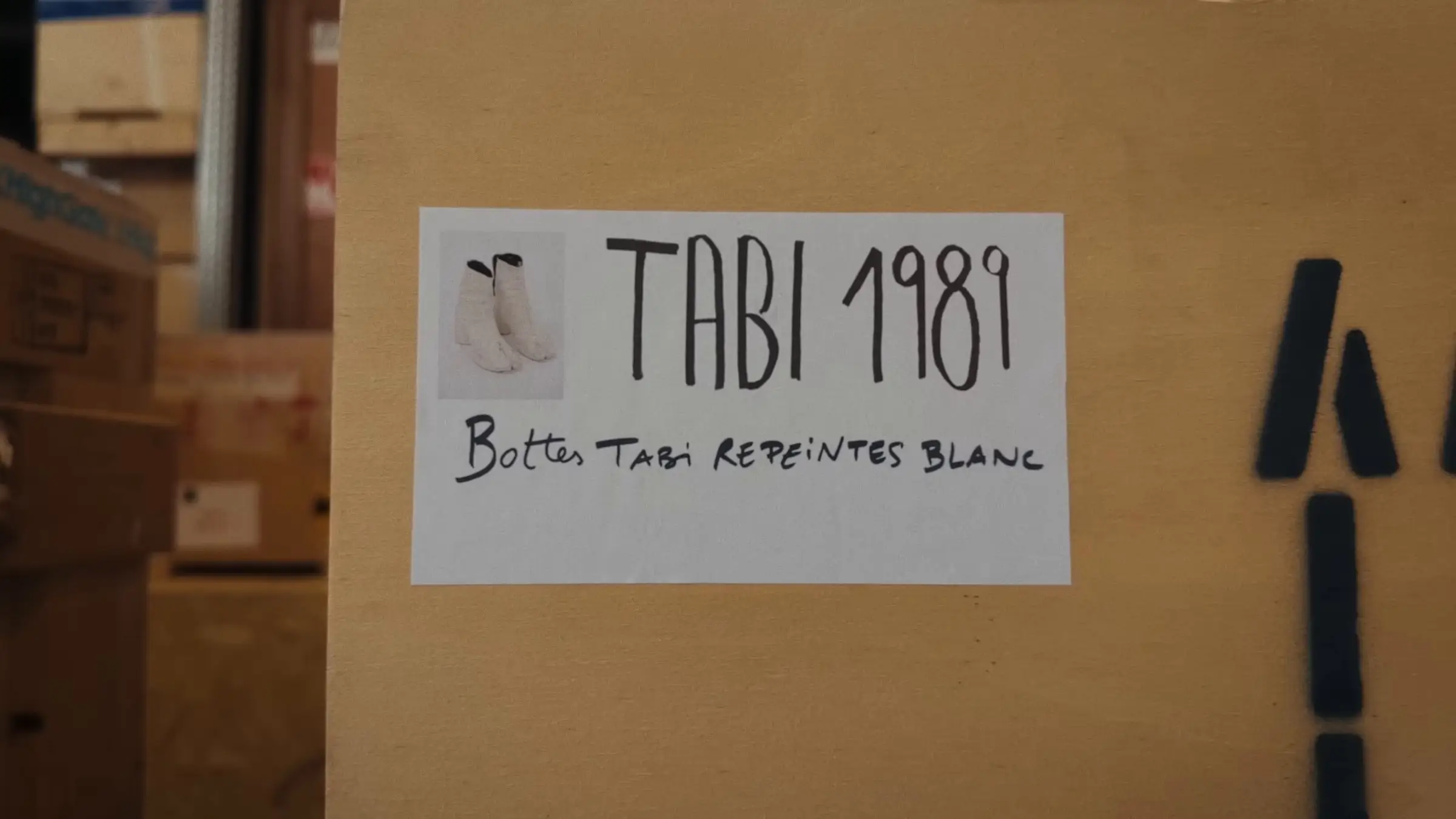 A box label in the house archive: Tabi 1989, boots repainted white.
