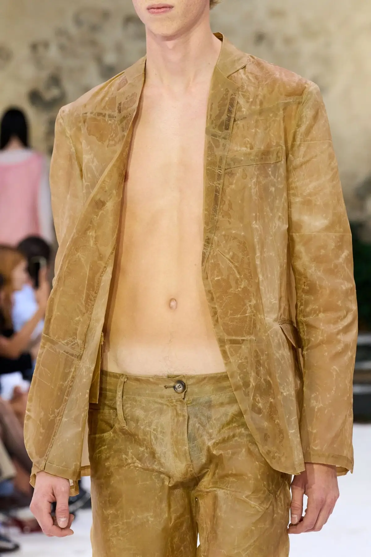Detail. A jacket worn open.