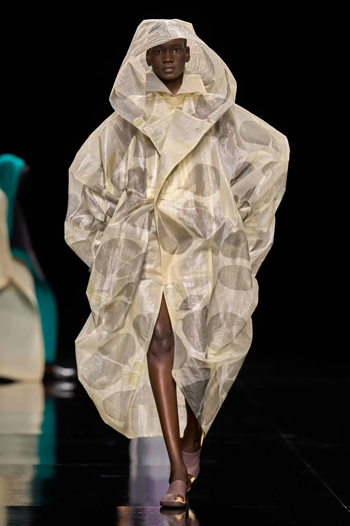 Look 44. A hooded coat in marbled, see through organza.