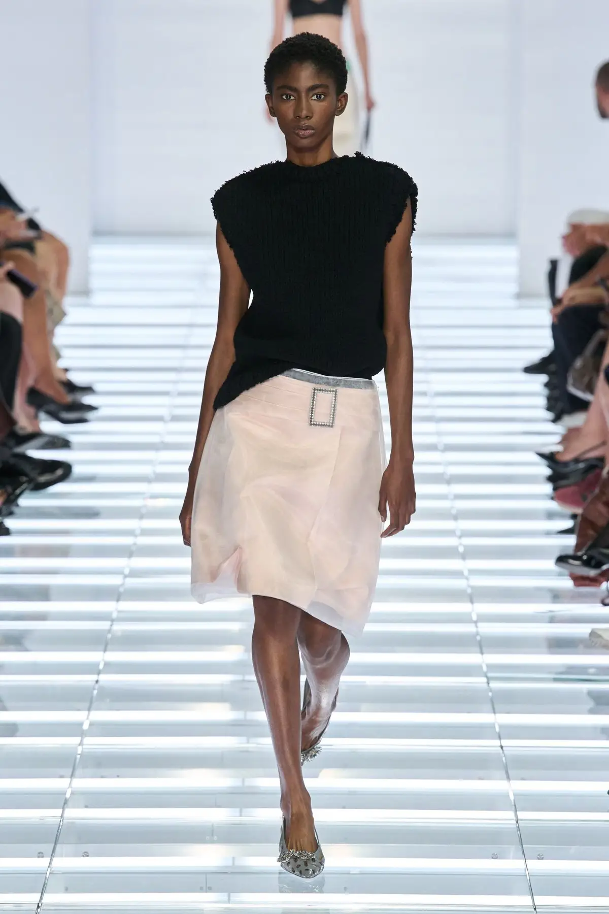 Look 20. A pale pink skirt under black.
