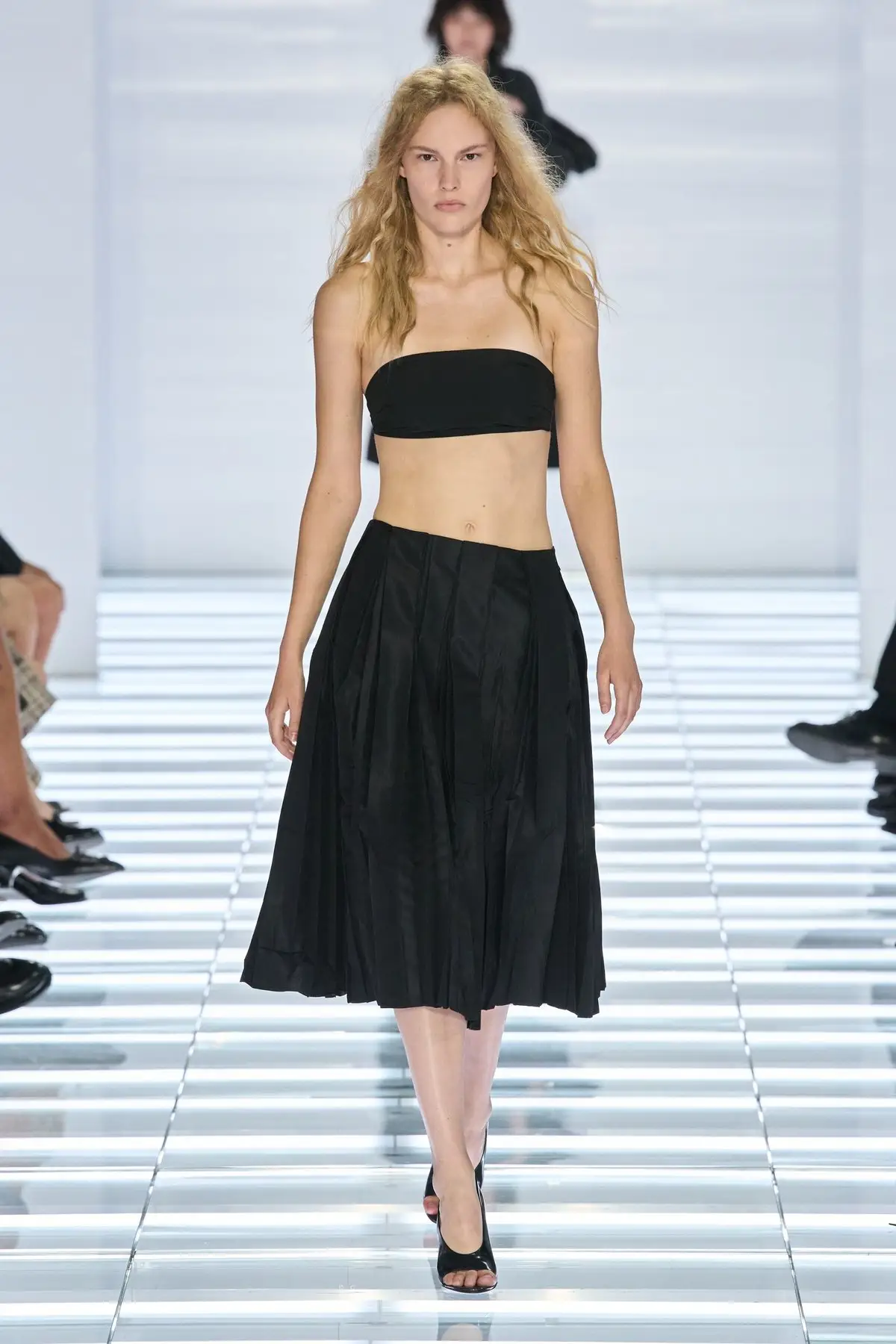 Look 41. Full black skirt, black bra top.